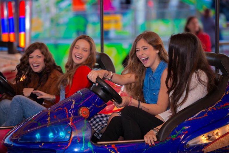 Thrill rides lit up at the fun fair