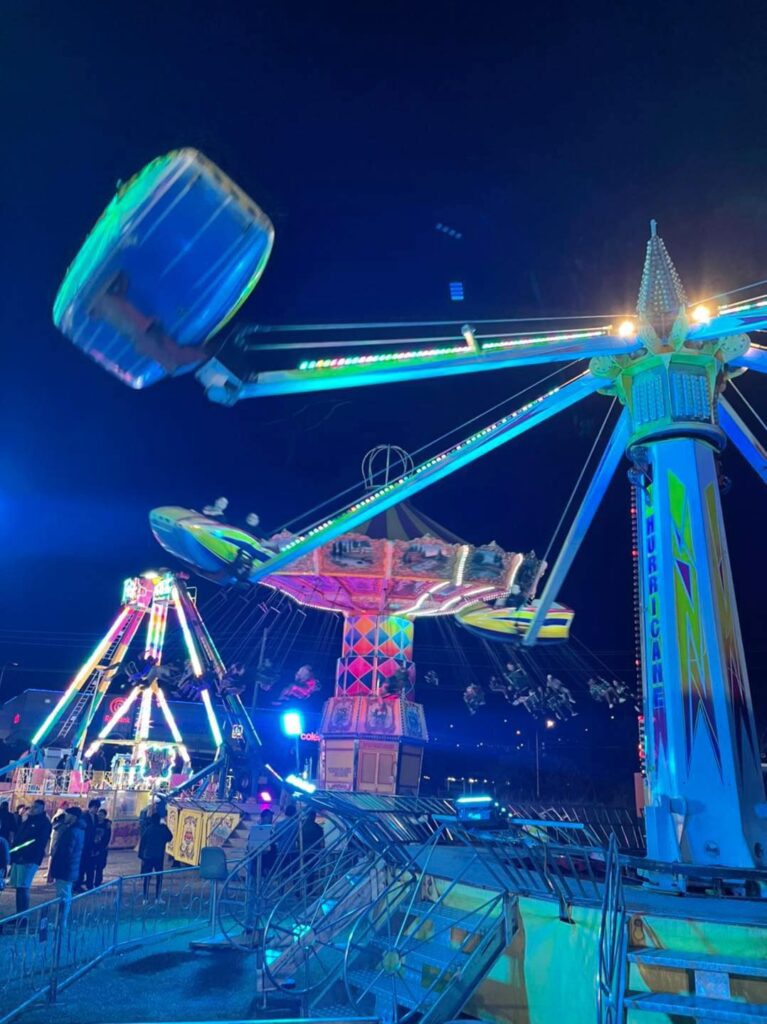 Friends laughing together on a carnival ride